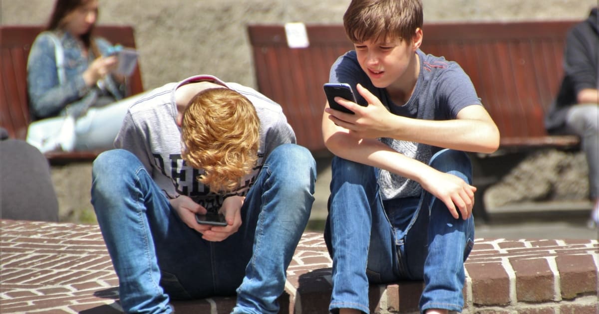 https://www.pexels.com/photo/2-boy-sitting-on-brown-floor-while-using-their-smartphone-near-woman-siiting-on-bench-using-smartphone-during-daytime-159395/